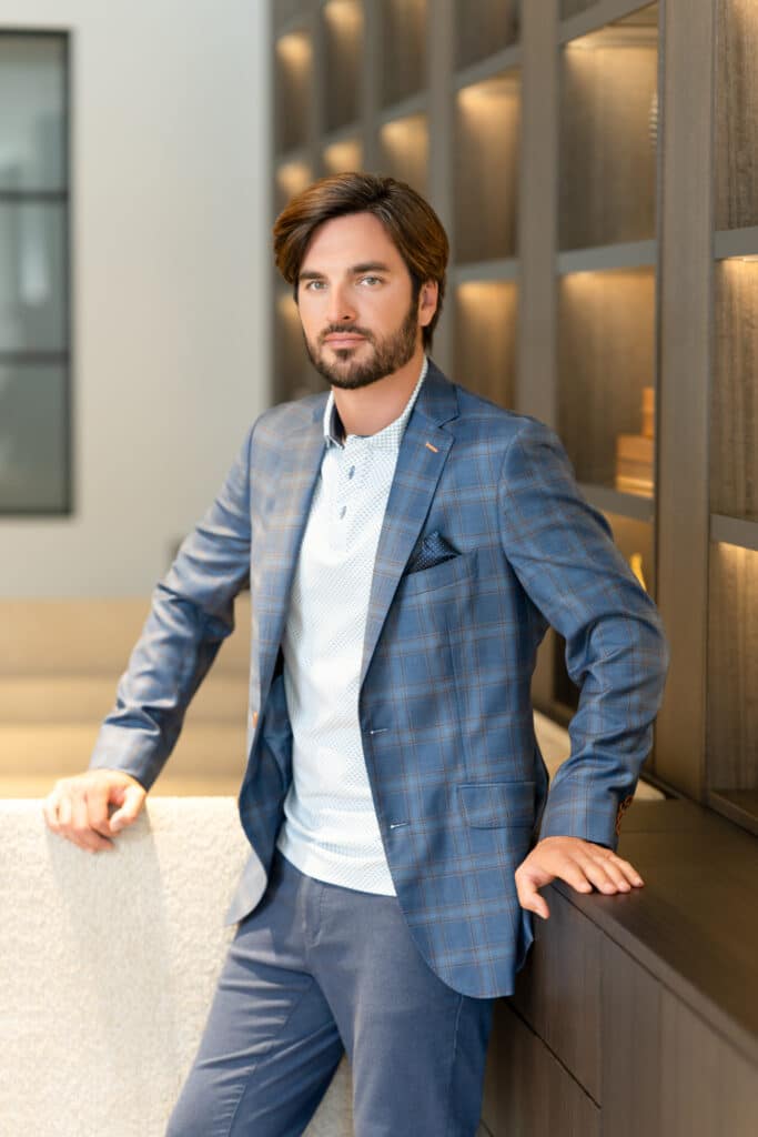 Branding lifestyle portrait of Tien Vo for J. Hilburn, captured outdoors in Newport Beach by Art of Portraits, showcasing modern menswear and personal style