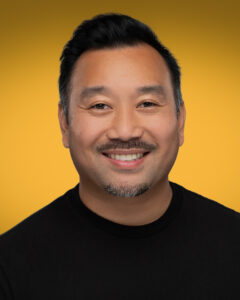 What Is a Headshot Photo? Understanding the Art Behind the Image 2 Professional headshot of Art of Portraits photographer with yellow gradient background.